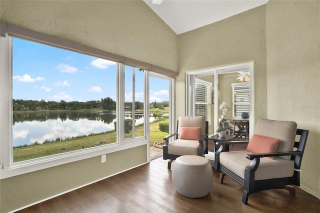 sunroom / solarium with a water view and vaulted ceiling