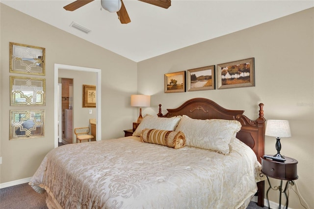 bedroom featuring ceiling fan, lofted ceiling, connected bathroom, and carpet flooring