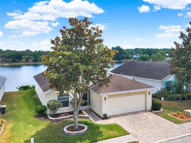 view of front facade featuring central air condition unit, a water view, a front lawn, and a garage
