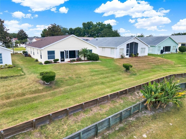 back of property featuring a yard
