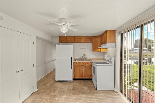 kitchen featuring sink, a water view, a textured ceiling, ceiling fan, and white appliances