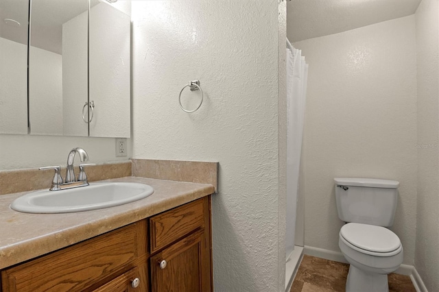 bathroom featuring vanity, toilet, and curtained shower