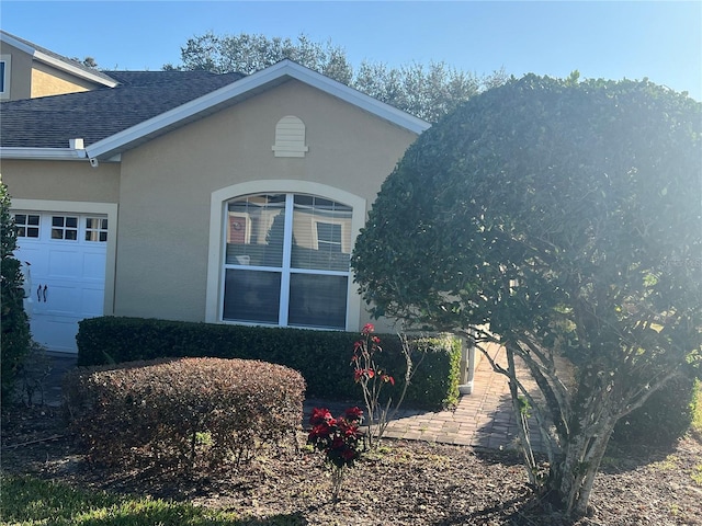 view of side of home with a garage