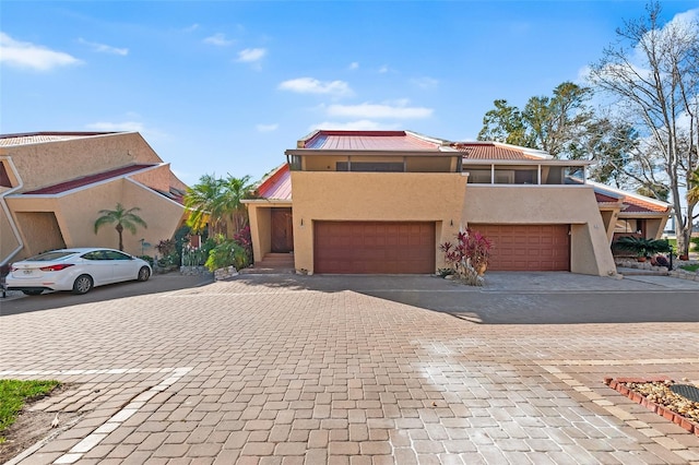 view of front of property featuring a garage and a balcony