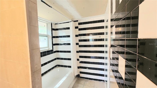 bathroom with a bathtub and tile patterned floors