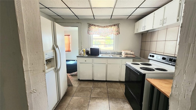 kitchen with white cabinetry, sink, electric range, and a drop ceiling