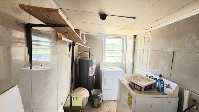 laundry area featuring washing machine and dryer and water heater