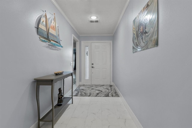 entryway with ornamental molding and a textured ceiling