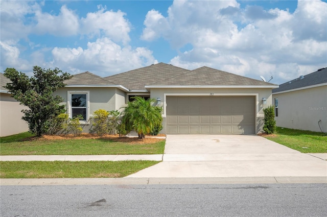 ranch-style home with a garage and a front yard