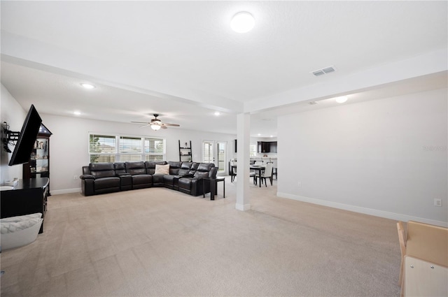 living room with ceiling fan and light carpet