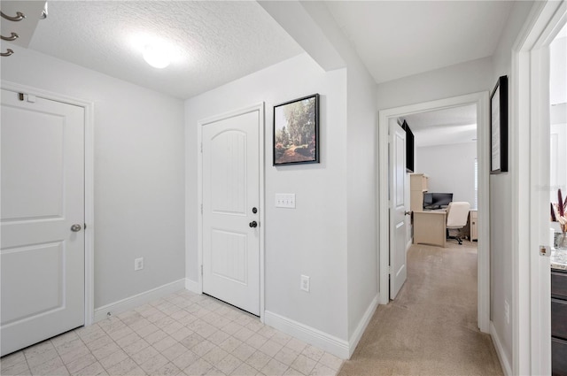 hall with a textured ceiling