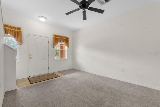 foyer with light carpet and ceiling fan