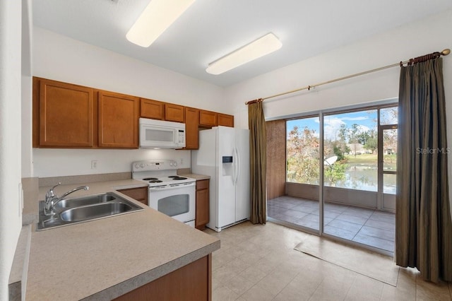 kitchen with sink and white appliances