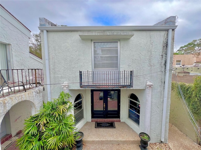 back of house featuring french doors and a balcony