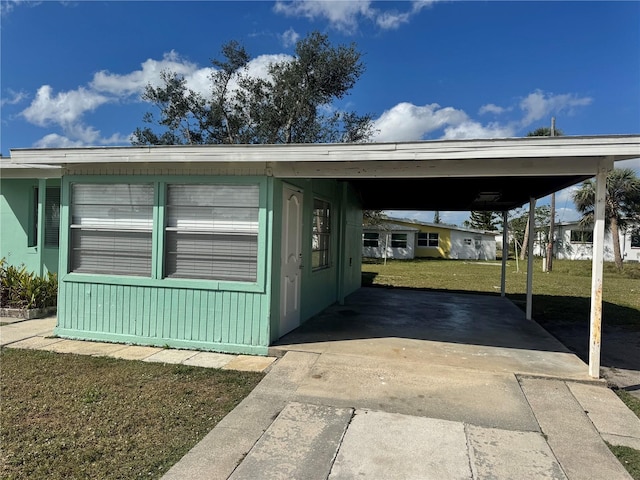 exterior space featuring a carport and a yard