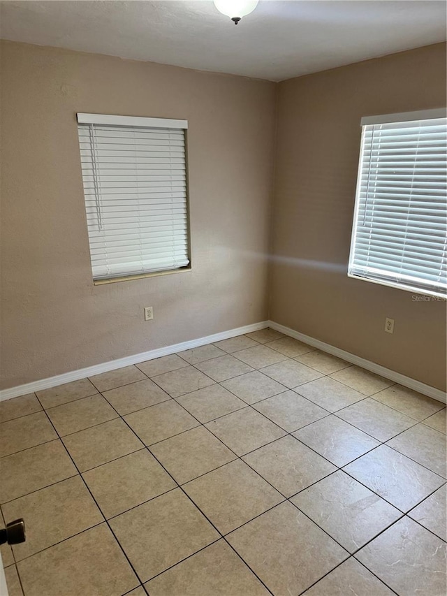 unfurnished room with light tile patterned floors