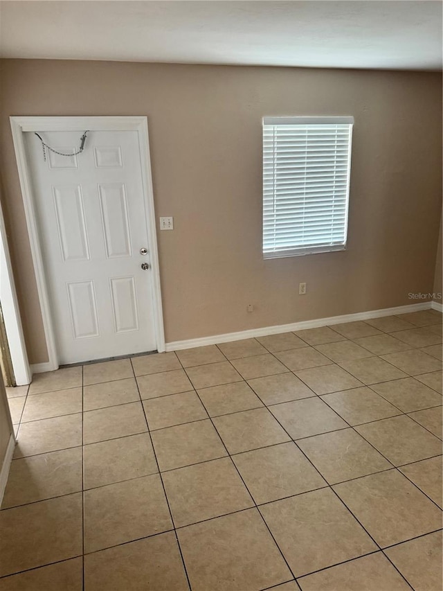 unfurnished room with light tile patterned floors