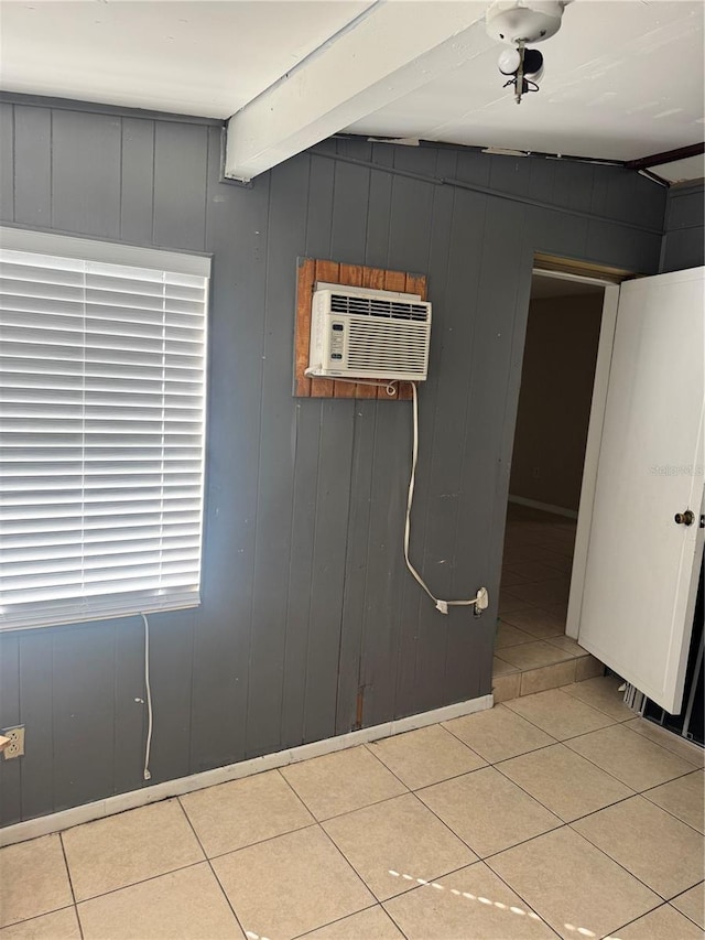 interior space featuring a wall mounted air conditioner and beam ceiling