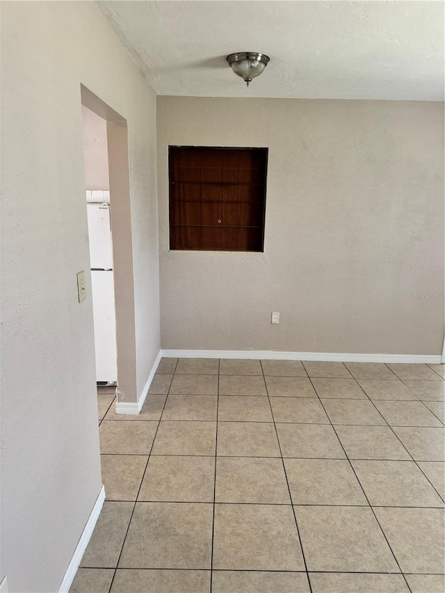 spare room featuring light tile patterned floors