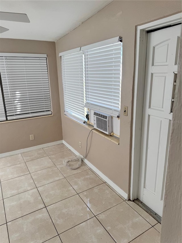 unfurnished room with light tile patterned floors, ceiling fan, and cooling unit