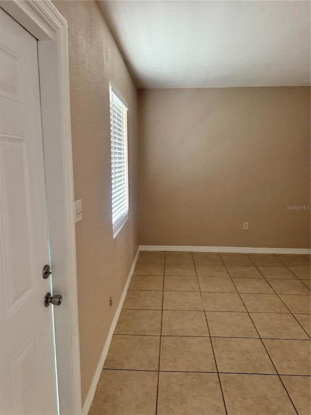 spare room featuring light tile patterned flooring