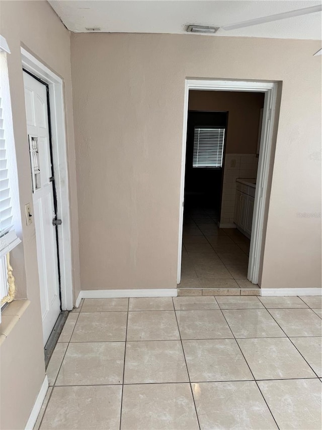 corridor with light tile patterned floors