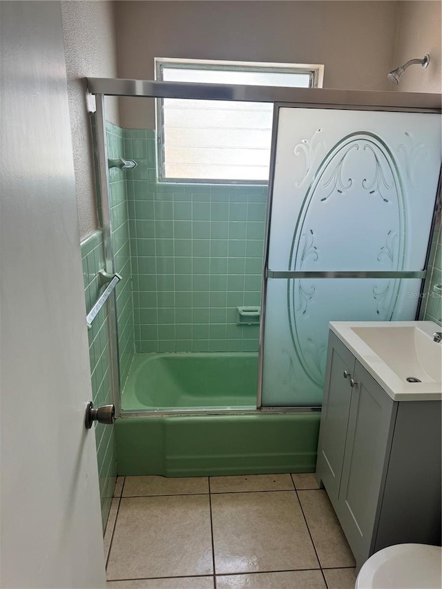 full bathroom featuring tiled shower / bath, toilet, tile patterned floors, and vanity