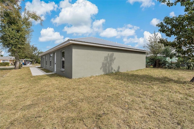 view of side of property with a yard