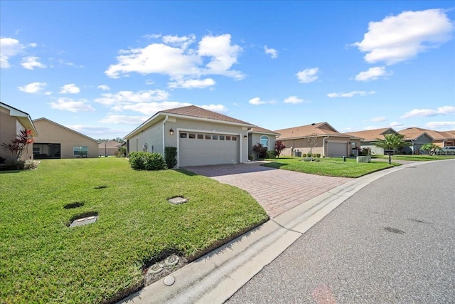 single story home with a residential view, decorative driveway, an attached garage, and a front yard