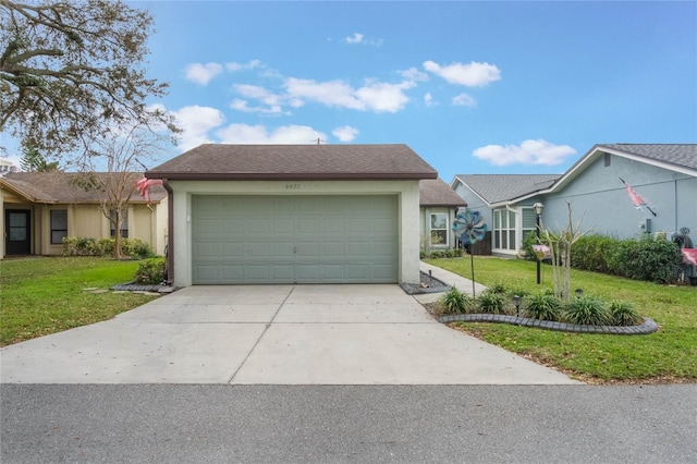 view of front of property featuring a front yard and a garage