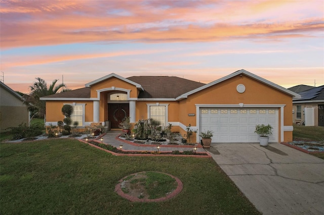 ranch-style home with a lawn and a garage