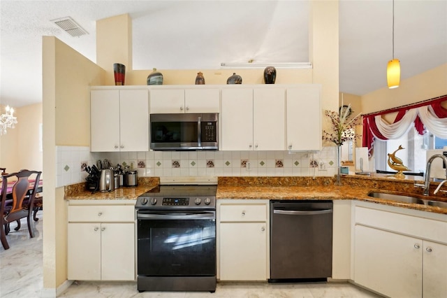 kitchen with decorative light fixtures, white cabinetry, stainless steel appliances, and sink