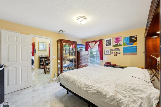 bedroom featuring a textured ceiling