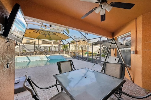 view of patio / terrace with ceiling fan and a lanai