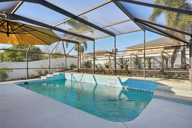 view of swimming pool featuring glass enclosure