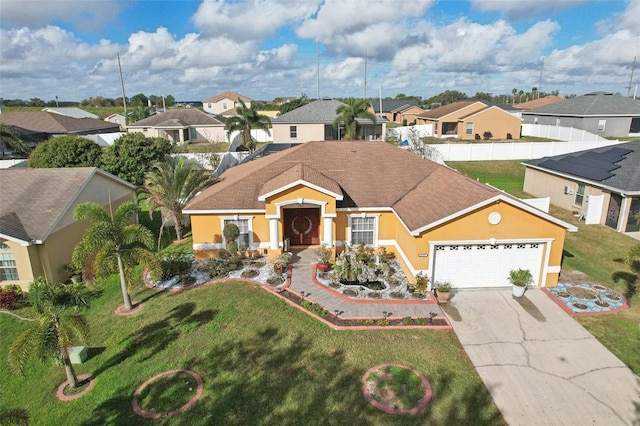 view of front of property featuring a garage and a front lawn