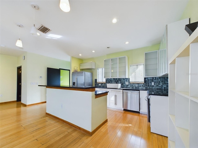1793 N Fort Harrison Ave, Clearwater, FL 33755 - kitchen featuring stainless steel appliances, a center island, light hardwood / wood-style floors, white cabinets, and decorative light fixtures