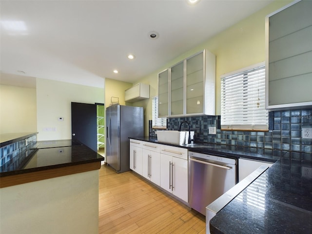 1793 N Fort Harrison Ave, Clearwater, FL 33755 - kitchen featuring sink, tasteful backsplash, appliances with stainless steel finishes, light hardwood / wood-style floors, and white cabinets