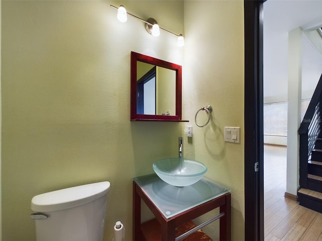 1793 N Fort Harrison Ave, Clearwater, FL 33755 - bathroom with hardwood / wood-style flooring, vanity, and toilet