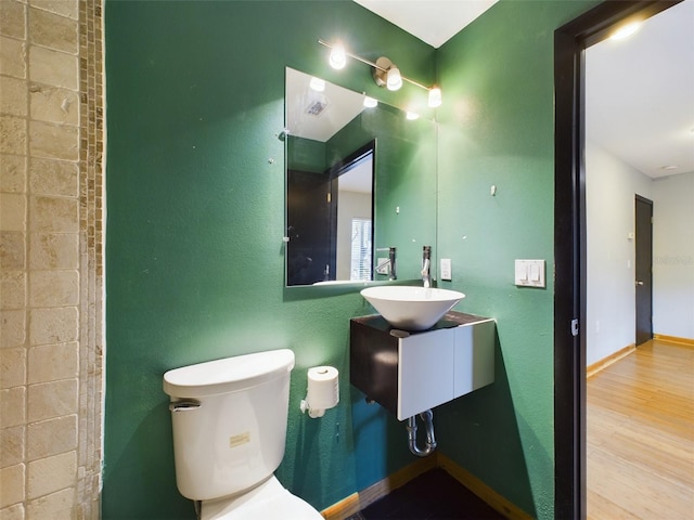 1793 N Fort Harrison Ave, Clearwater, FL 33755 - bathroom featuring wood-type flooring, sink, and toilet