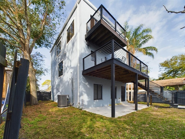 1793 N Fort Harrison Ave, Clearwater, FL 33755 - back of house with central AC unit, a yard, and a patio