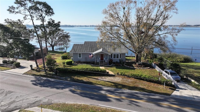 single story home featuring concrete driveway and a water view