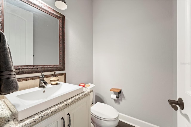 bathroom with toilet and vanity