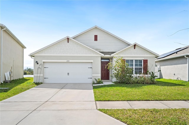 view of front of house with an attached garage, concrete driveway, and a front yard