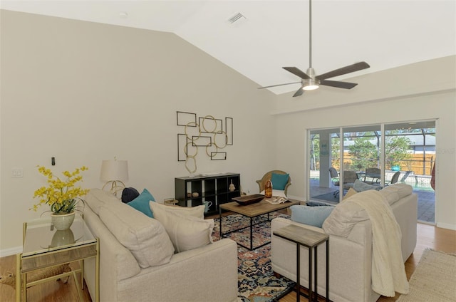 living room featuring light hardwood / wood-style flooring, ceiling fan, and vaulted ceiling