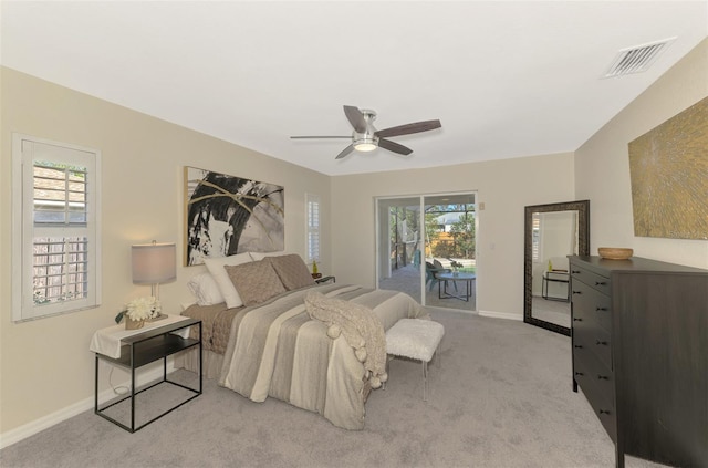 bedroom featuring light carpet, ceiling fan, and access to exterior