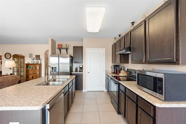 kitchen with appliances with stainless steel finishes, light countertops, dark brown cabinets, under cabinet range hood, and a sink