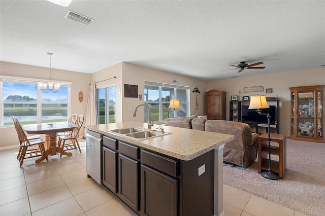 kitchen with visible vents, dishwasher, light countertops, pendant lighting, and a sink