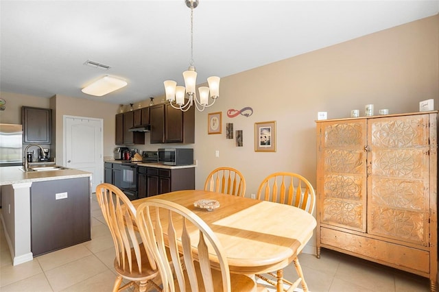 dining room featuring light tile patterned flooring, visible vents, and an inviting chandelier