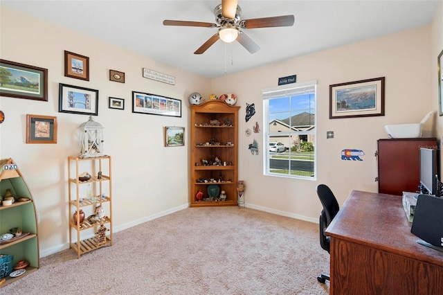 office space featuring baseboards, a ceiling fan, and carpet flooring